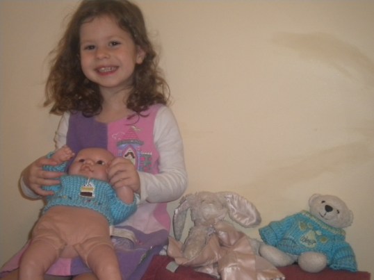 The party crew: Dylan, holding Ariel in her PJ's, Eric, and King Triton