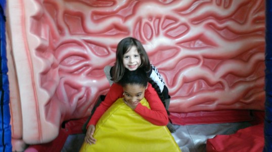 The cousins are doing body slams in Big Ed's stomach