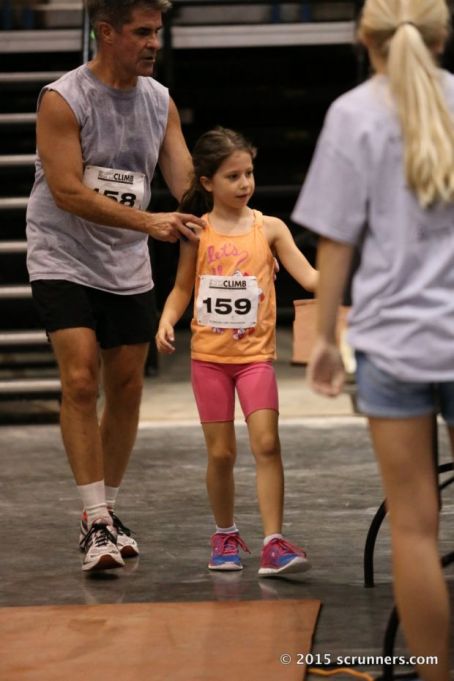 Waving her timing bracelet at the Finish Line